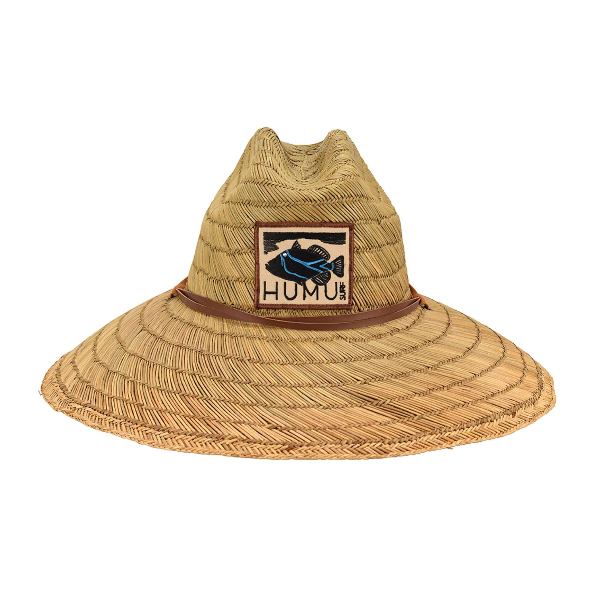 A natural straw wide-brim sun hat with a brown leather band and embroidered Humu Surf fish patch logo and the text 'HUMU SURF'.