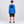 Load image into Gallery viewer, Boy modeling the Maui Ocean Blue Kids Rash Guard from behind, showing the large black Humu Surf fish logo across the back
