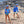 Load image into Gallery viewer, Two children wearing Humu Maui Ocean Blue Kids Long Sleeve Rash Guards and blue Molokini Trucker Hats on a rocky beach
