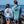 Load image into Gallery viewer, Man and woman wearing Humu Woody Bamboo Lightweight Hoodies with large back fish graphics by the ocean
