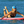 Load image into Gallery viewer, Woman wearing the blue Humu Molokini Trucker Hat while lying on a paddleboard in the ocean
