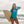 Load image into Gallery viewer, Woman holding a surfboard while wearing the Humu Original Royal Blue Trucker Hat and blue long-sleeve rashguard
