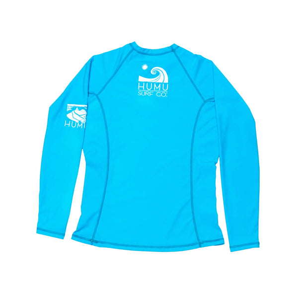 Back view of the Humu Women's Wahine Kore-Dry Rashguard in Hawaii Blue showing the white Humu Surf Co. wave logo and sleeve artwork