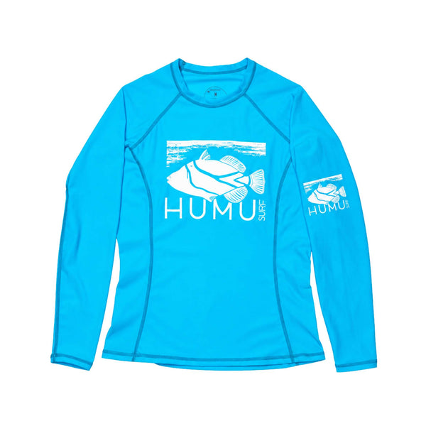 Women's Wahine Kore-Dry Long Sleeve Rashguard in Hawaii Blue laid flat, showing the white Humu Surf fish logo, raglan sleeves, and fitted shape.