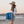 Load image into Gallery viewer, Side profile of a woman wearing the Humu Classic Lifeguard Hat on the beach while carrying a folded blue Humu Surf brand Live With AlohaSurf towel

