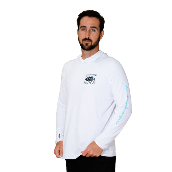 Man modeling the white Humu Men's Woody Long Sleeve Performance Hoody with hood down, Humu fish chest logo, and turquoise sleeve lettering
