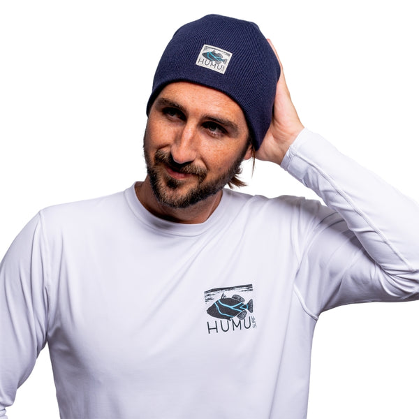 Man wearing the Navy Humu Surf Beanie with embroidered Humu fish logo patch