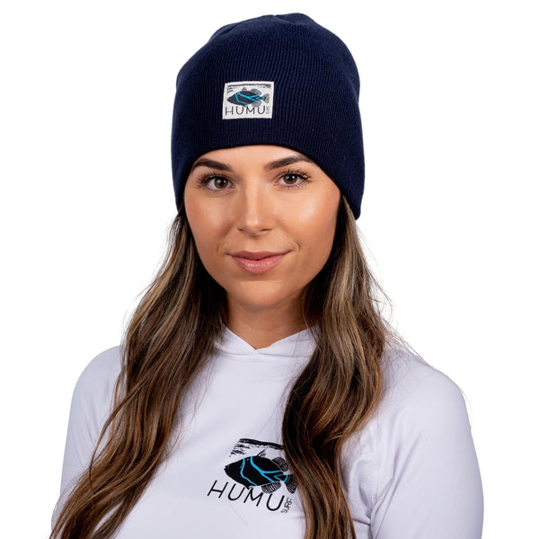 Front portrait of a woman wearing the Navy Humu Surf Beanie
